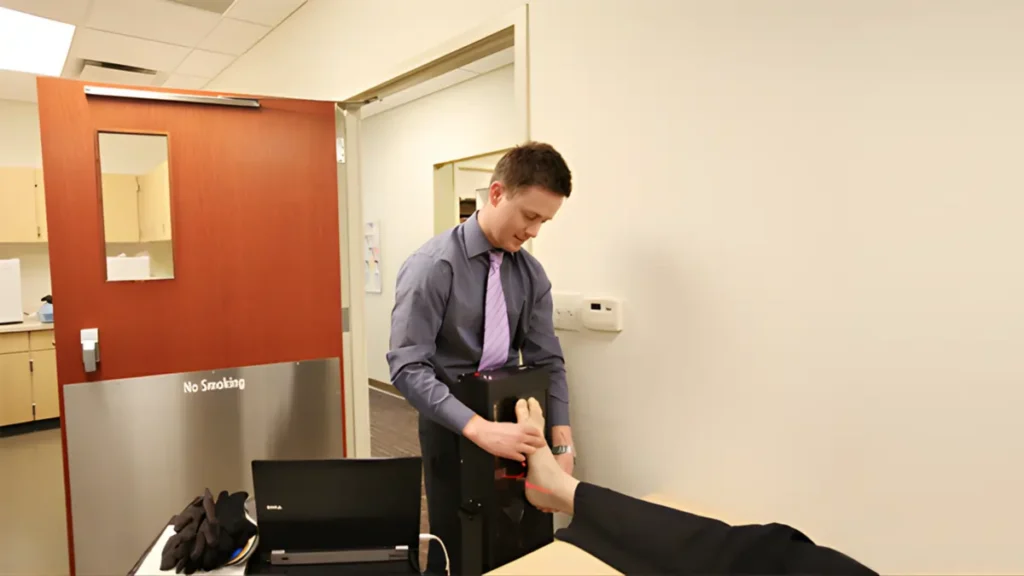 Dr. Hall of Kansas City Foot Specialists performing a foot examination on a patient.